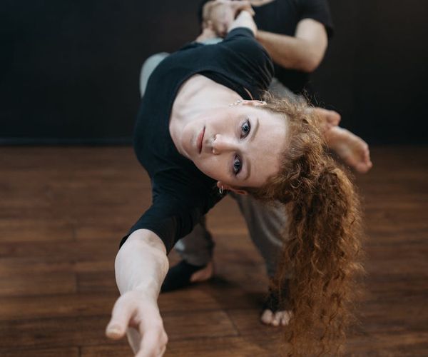 Man in a balancing pose, showing focus and physical control.